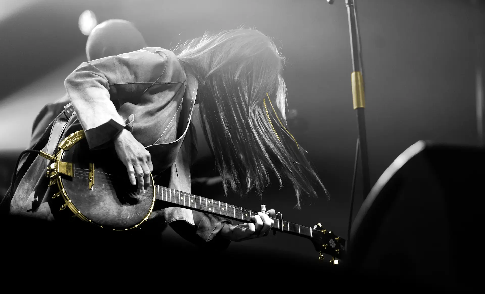 Woman musician playing a banjo on stage